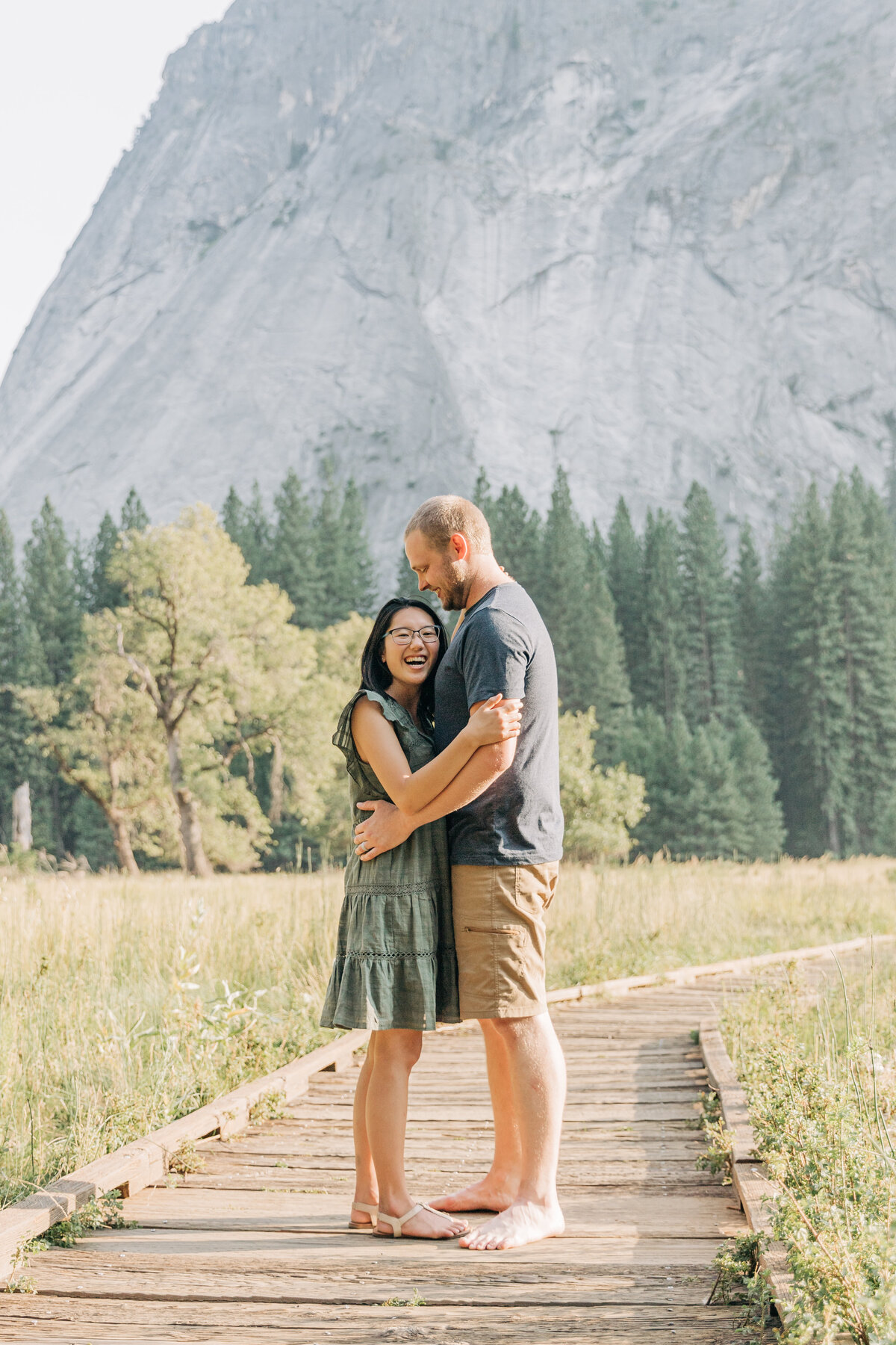 couple standing on a boardwalk by a mountain in Yosemite