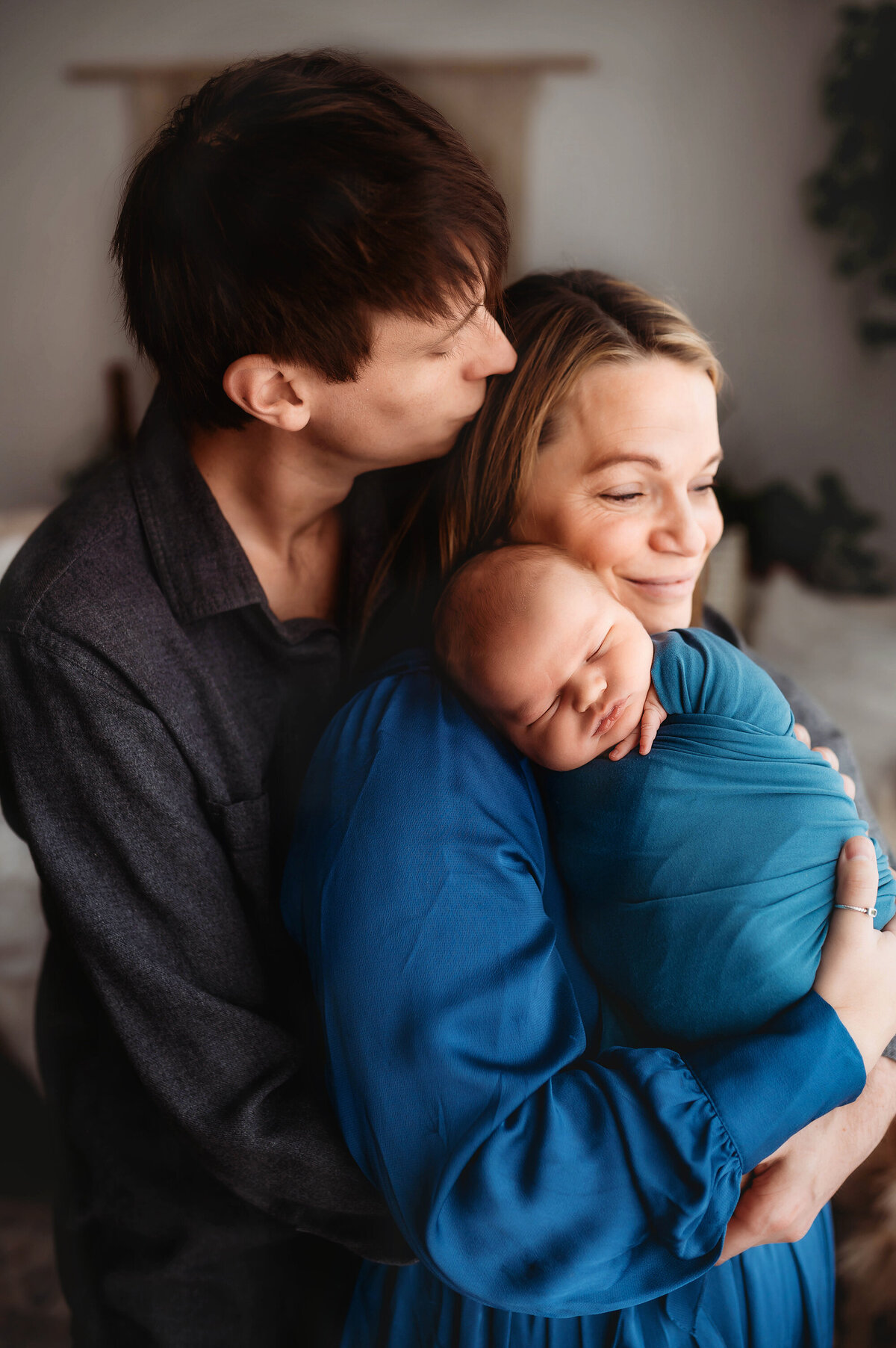 Parents embrace their infant during Newborn Portrait Session in Asheville, NC.