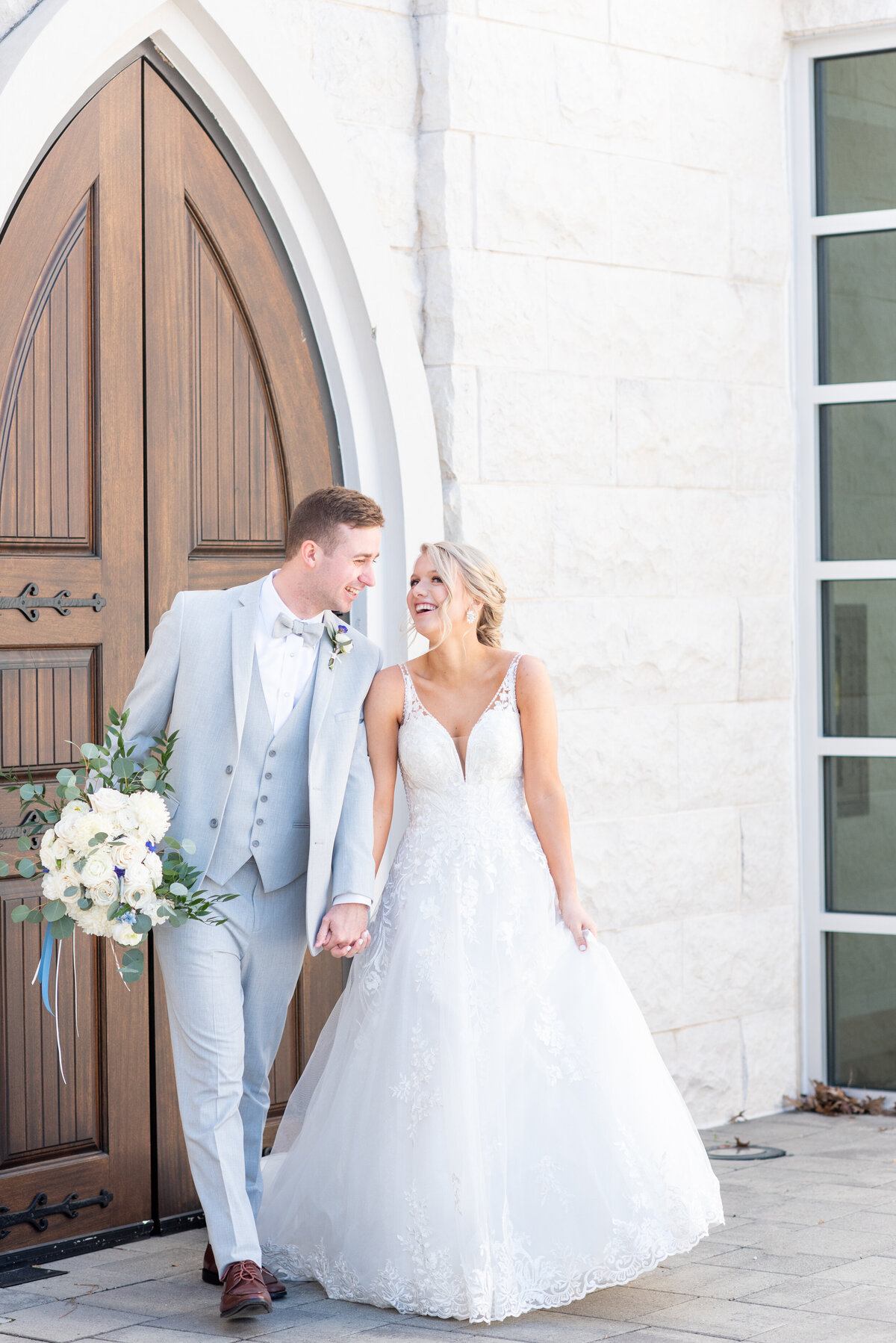 bride and groom walking hand in hand