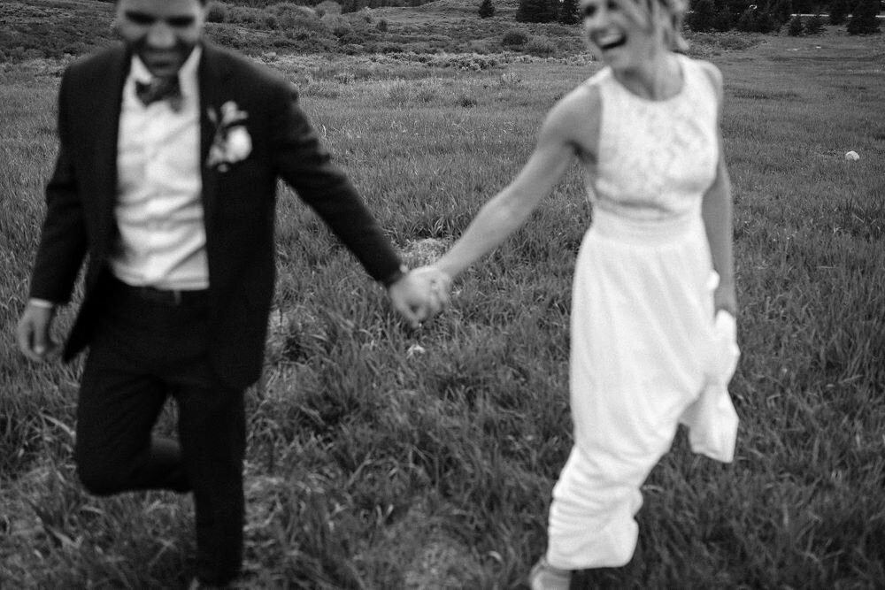 black and white photo of couple holding hands on wedding day