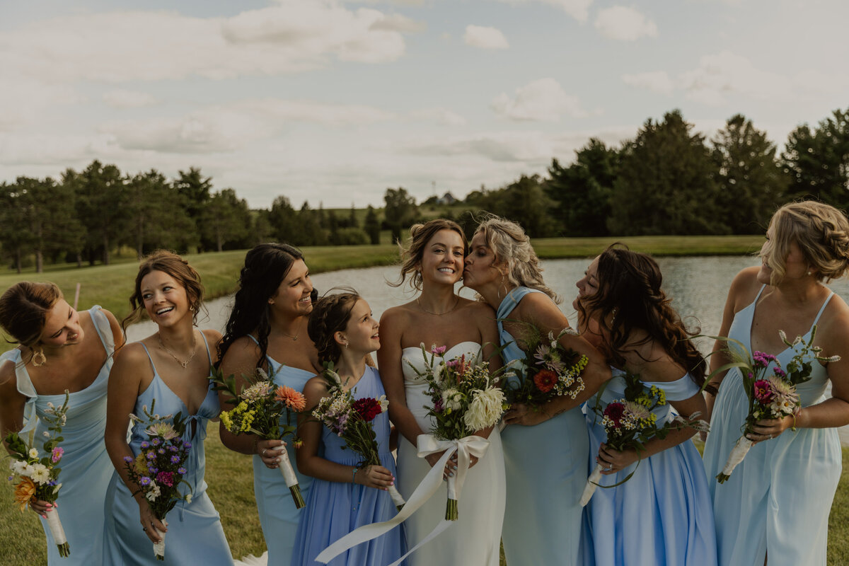 Bride and groom walking with wedding party and everyone is laughing captured by MN Wedding Photographer 