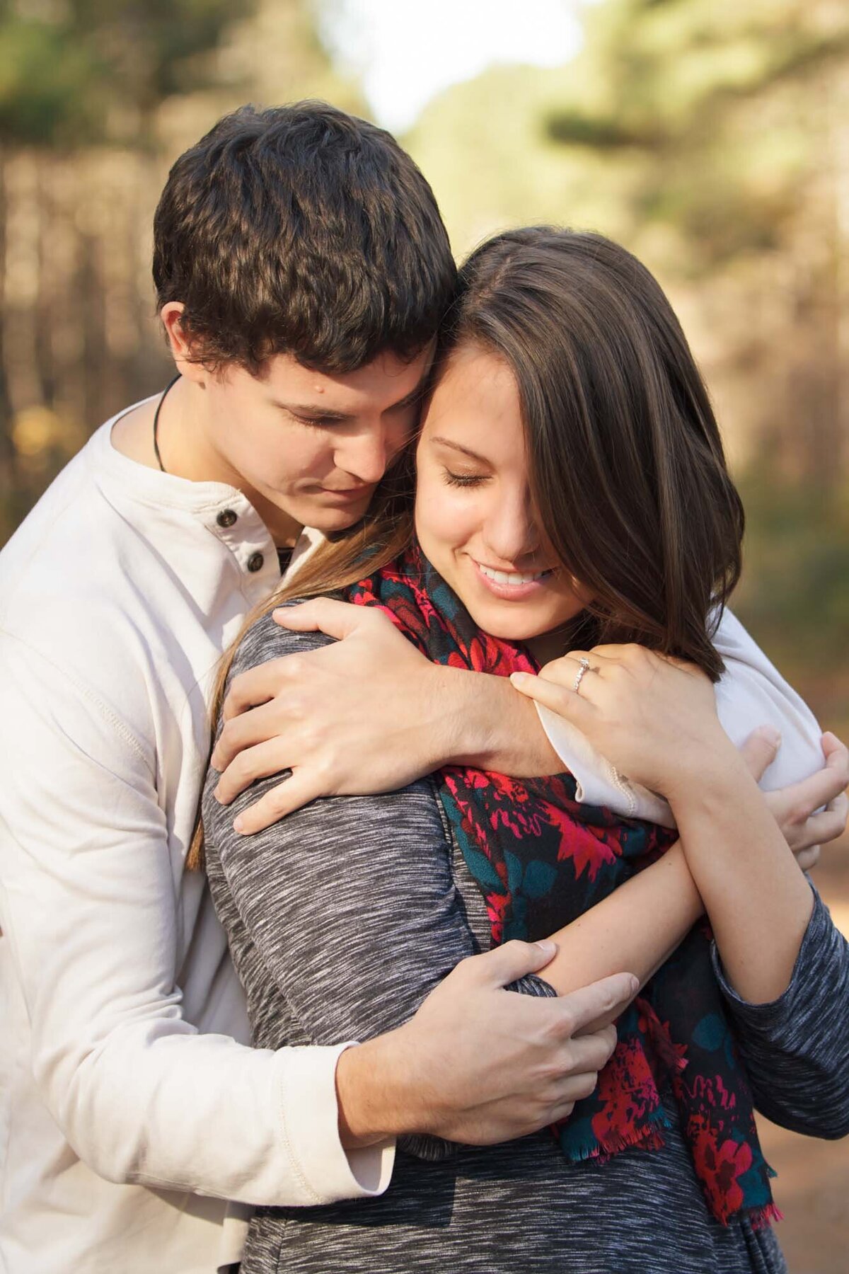 Man holding woman from behind.