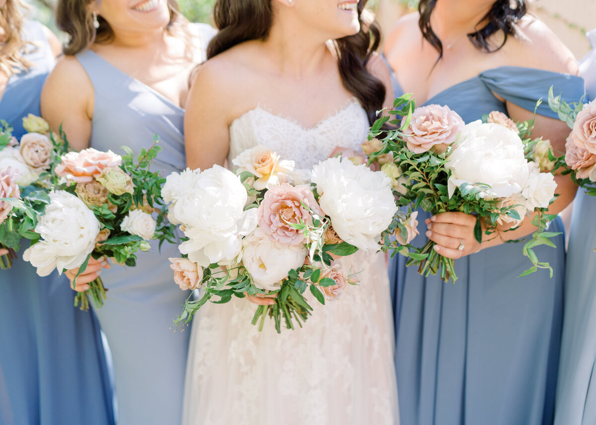 bride with bridesmaids in light blues gowns