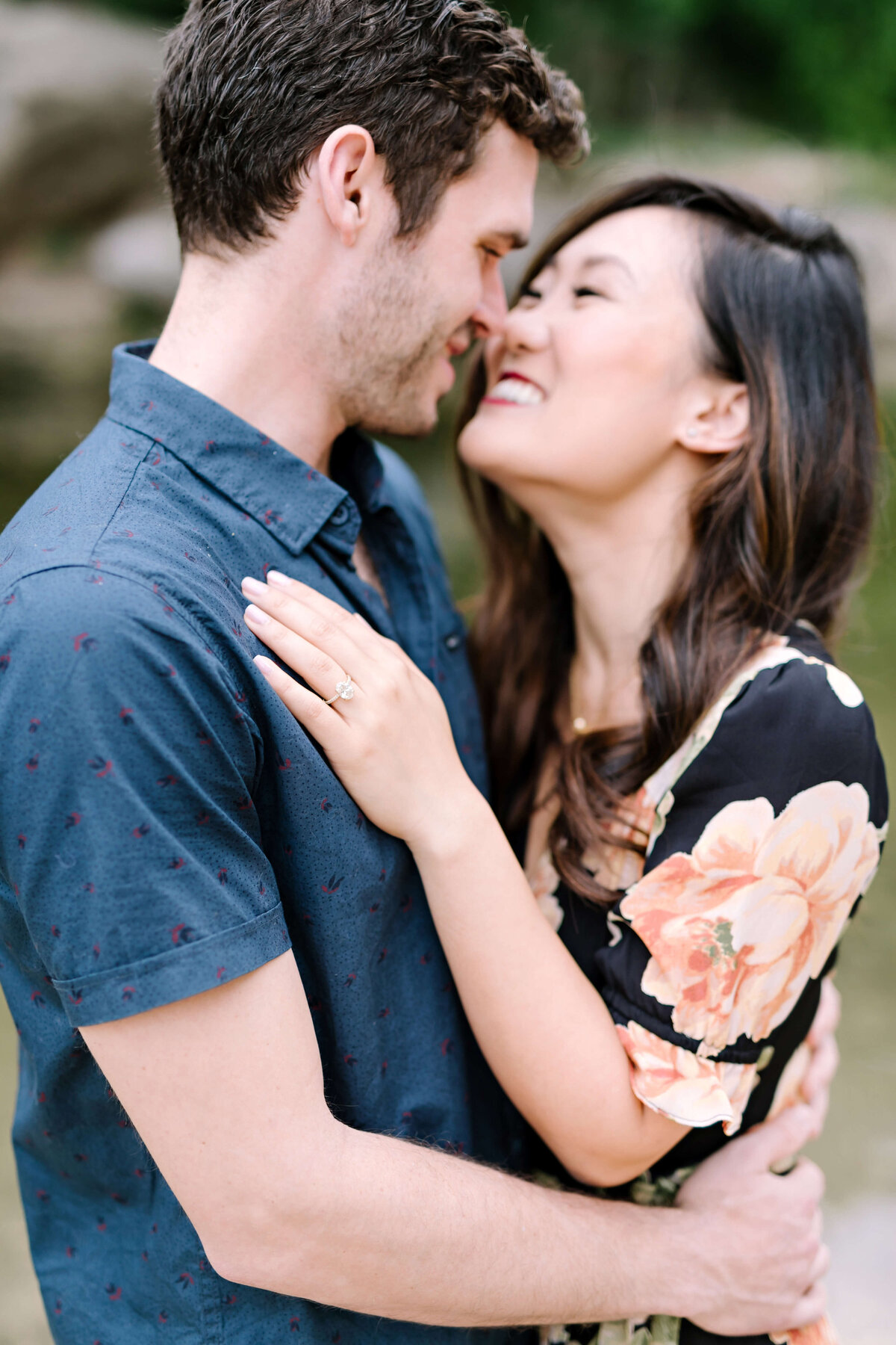 Bride in a black and orange floral dress for her engagement session