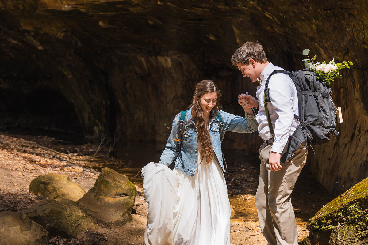 As part of their Indiana elopement packages, bride and groom go hiking