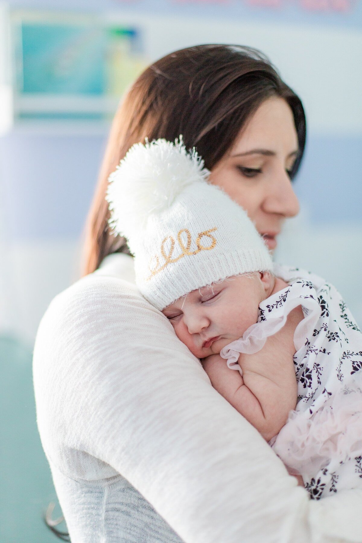 newborn baby on moms shoulder