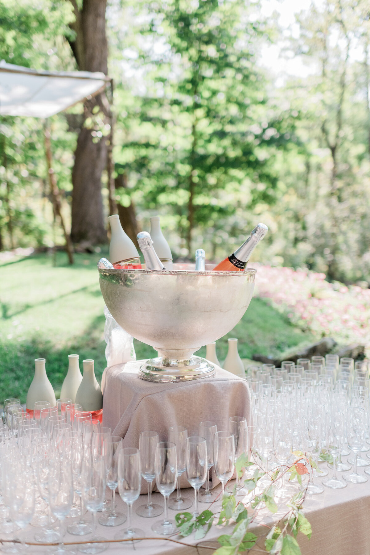 Bottles sit in a decorative wine bowl