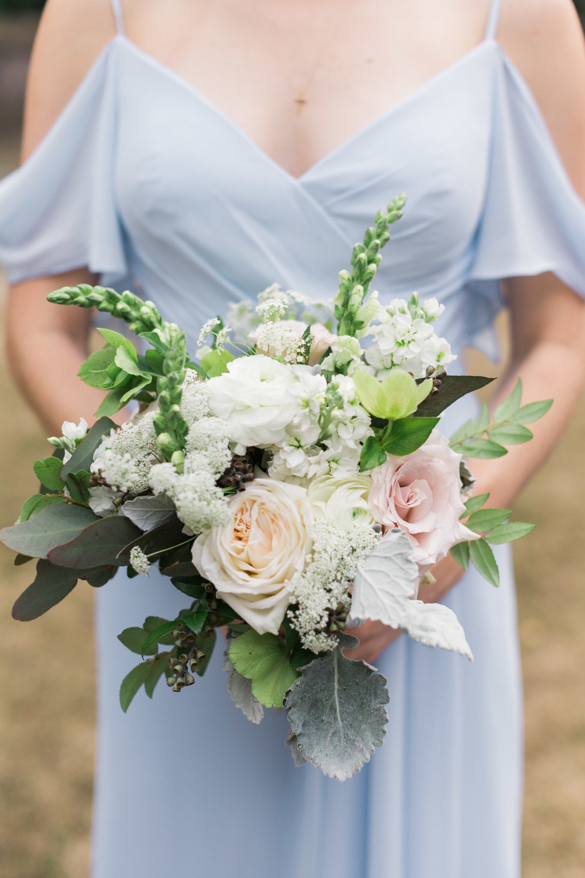 The light blue in these bridesmaid dresses played so well with these neutral floral bouquets. Photo by luxury destination wedding photographer Rebecca Cerasani.