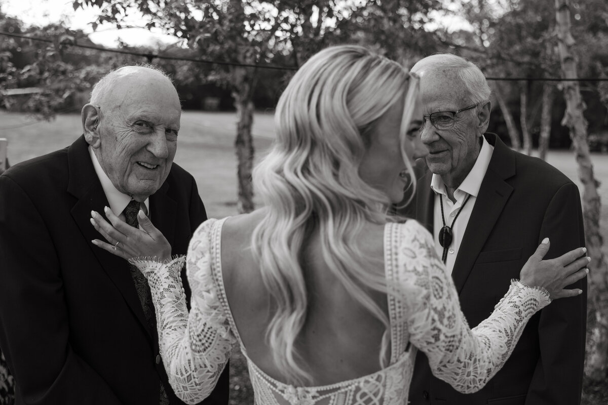 candid of bride and two grandpas