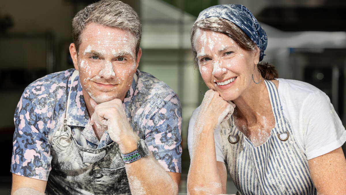 Two people covered in flower smiling