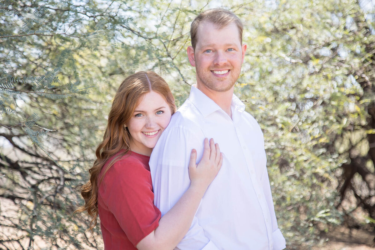 Redheaded couple in a desert park wearing red and white