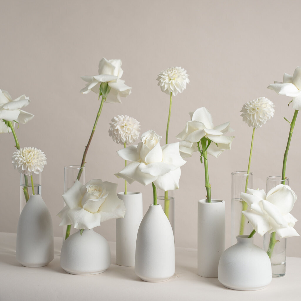 Elegant white centrepieces by Foxglove Studio, contemporary Calgary, Alberta wedding florist, featured on the Brontë Bride Vendor Guide.