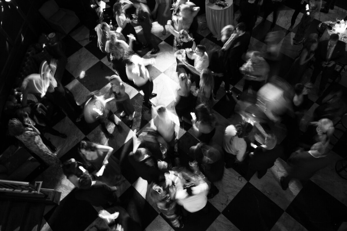 wedding guests dancing in black and white by best film wedding photographers Noble Photo Co
