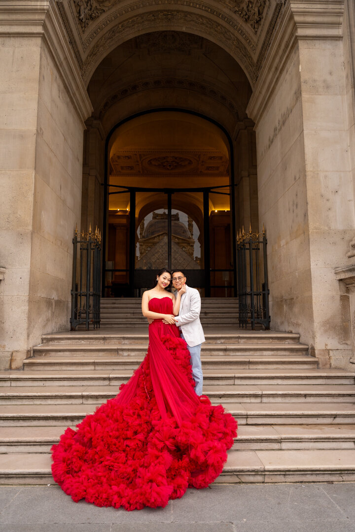 Pre-wedding photos Louvre courtyard, red princess dress, luxury Paris couple photography