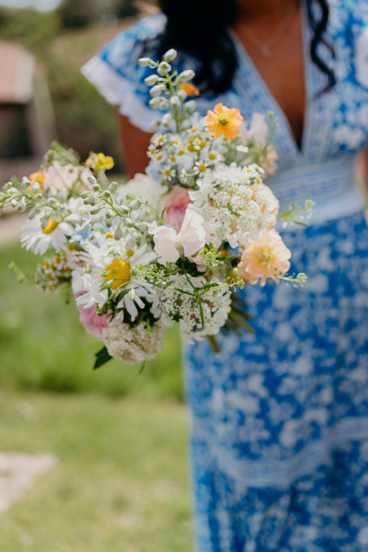Patterned bridesmaids dress with summery floral bouquet