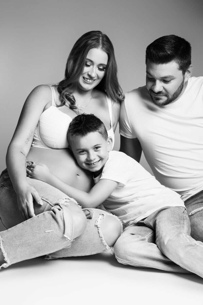 Family smiling and interacting with baby bump, taken by photographers new jersey Ally Kimpton Photography
