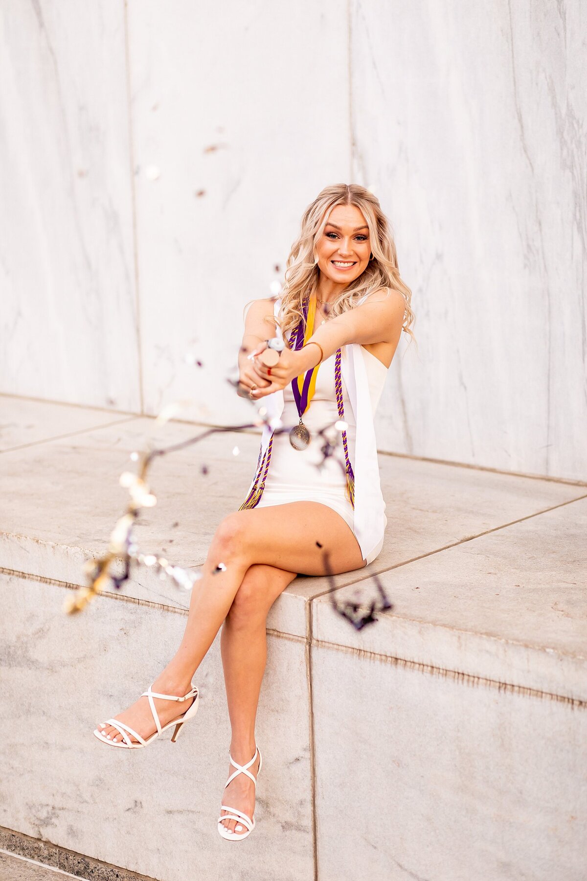 College of Charleston graduate in historic Charleston streets photographed for joyful, personality-filled portraits