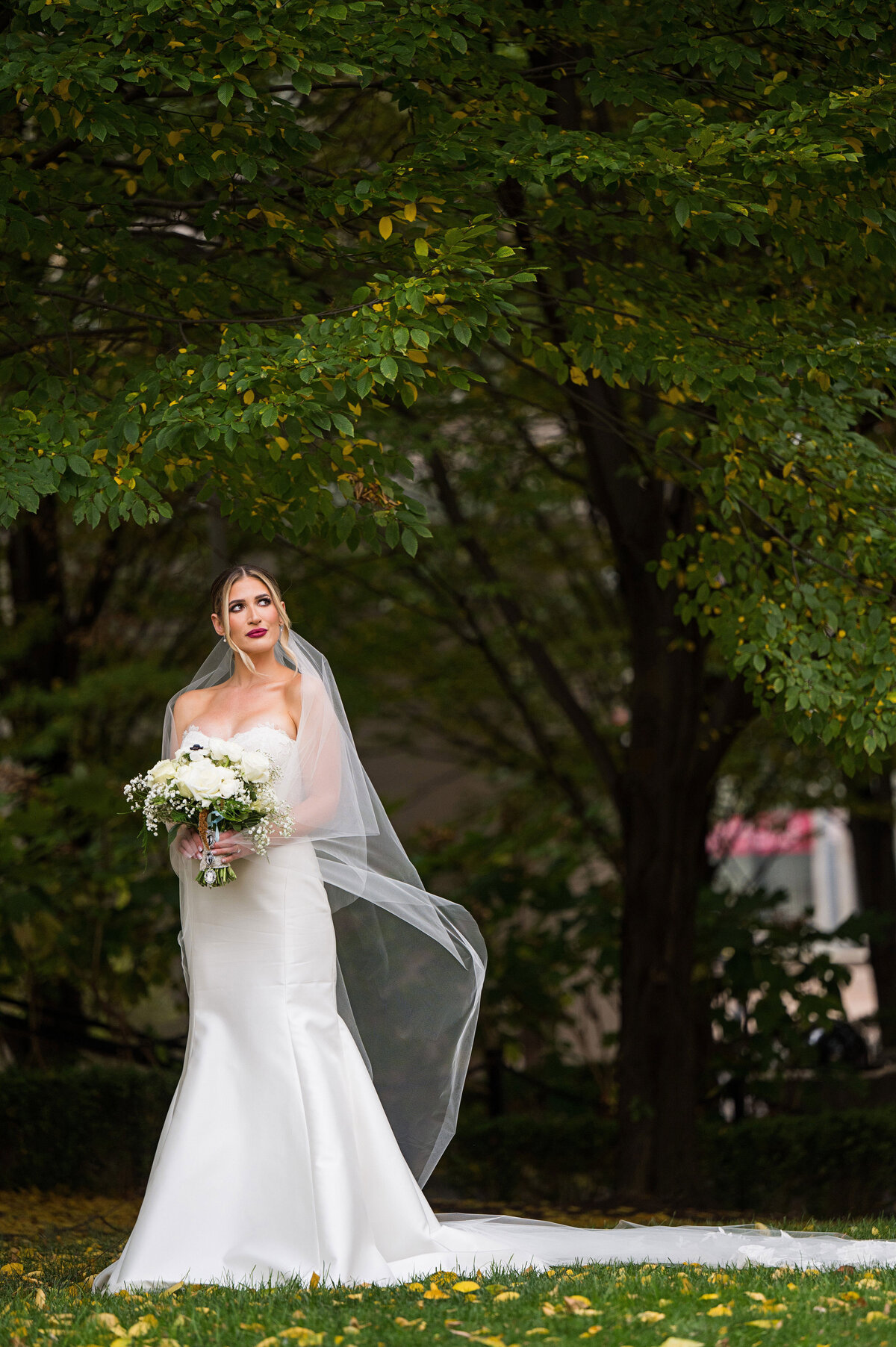 bride posing for wedding portrait on mellon green in pittsburgh