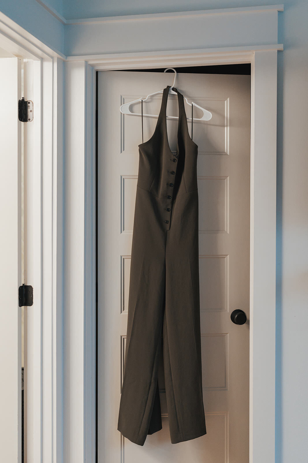 Wedding jumper hangs from a door handle