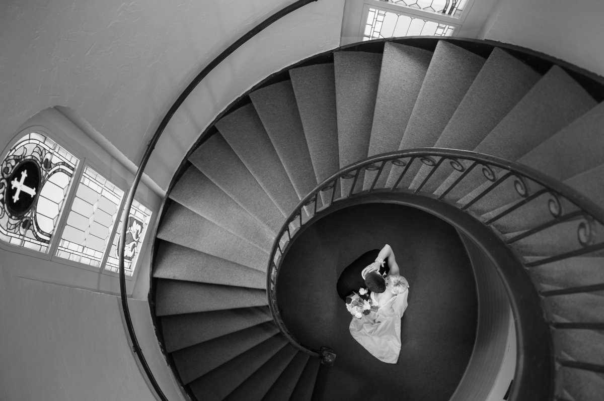 Bride and Groom at the bottom of a spiral staircase in Sacred Heart Church in Downtown Tampa, FL