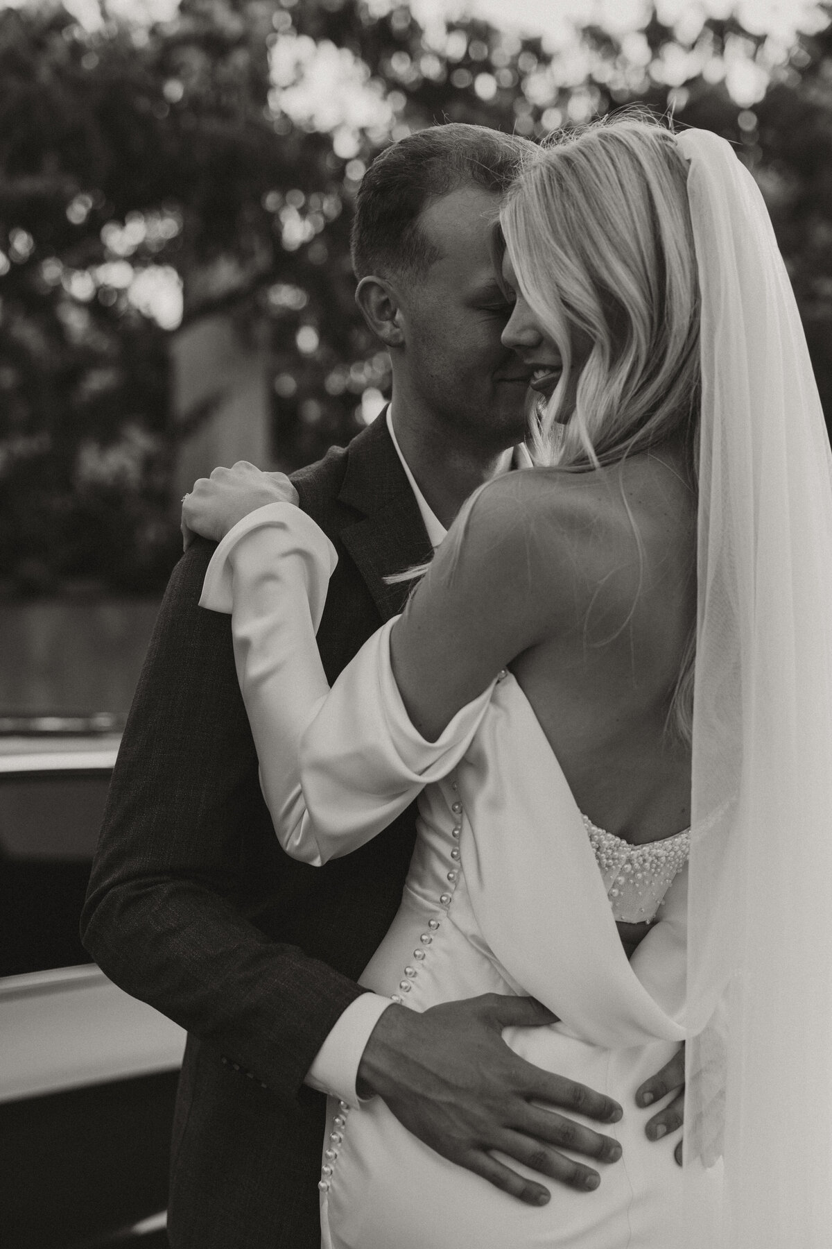 bride and groom embracing, sexy wedding dress, wedding veil 