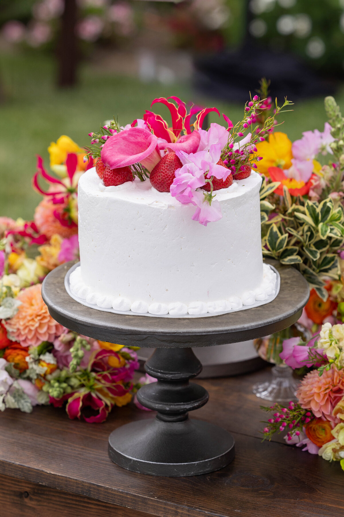 White cake with pink flowers on top