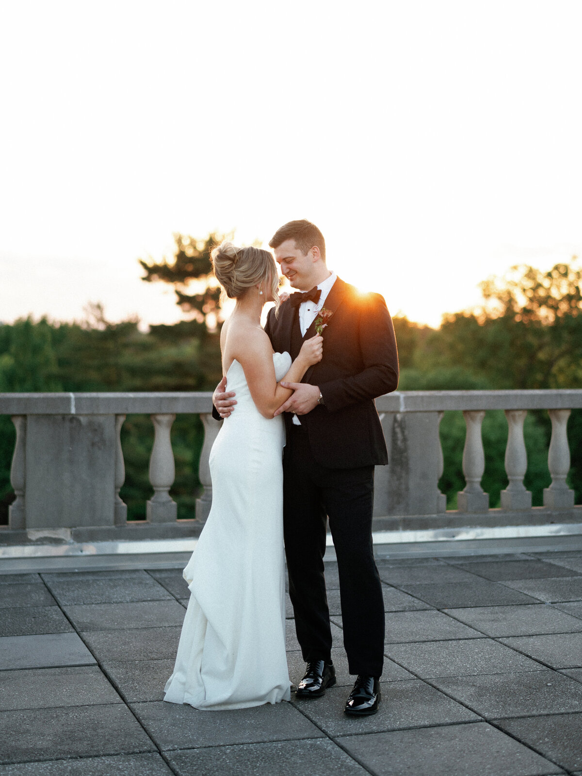 bride and groom staring lovingly into each others eyes during sunset.