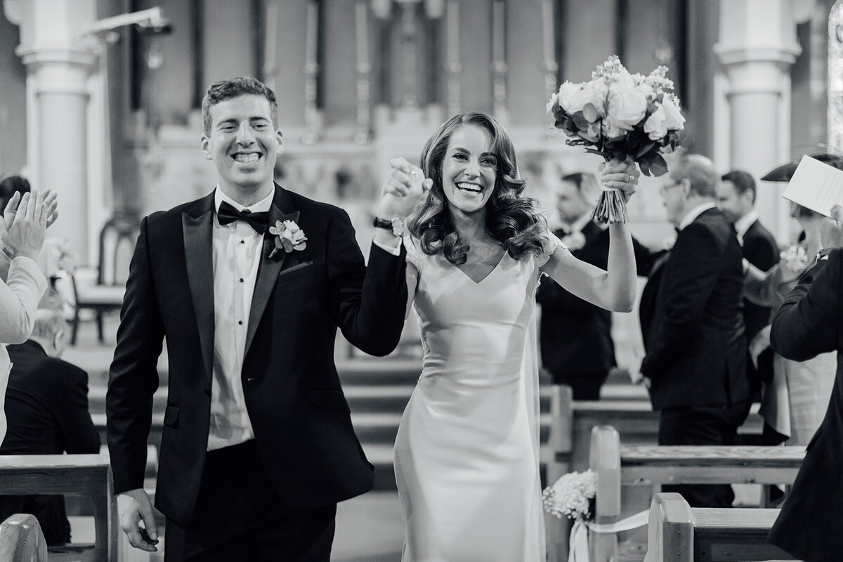 bride-and-groom-exit-lifting-hands