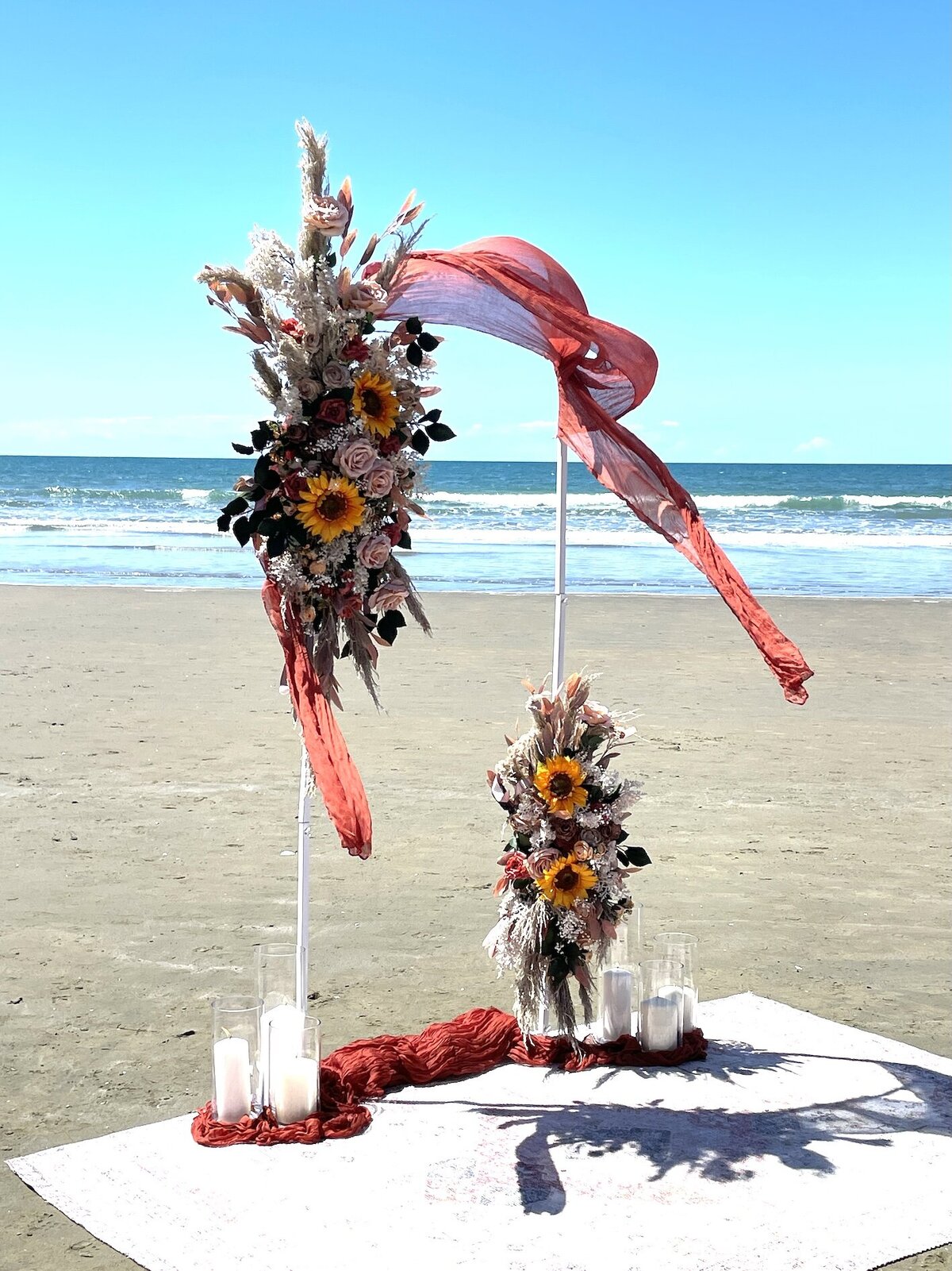 Elopement setup with floral arch and ocean view
