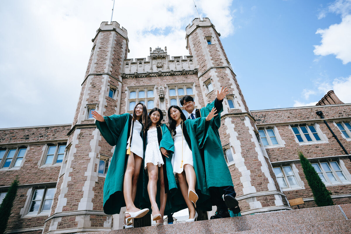 group of 4 graduating friends in front of brookings hall