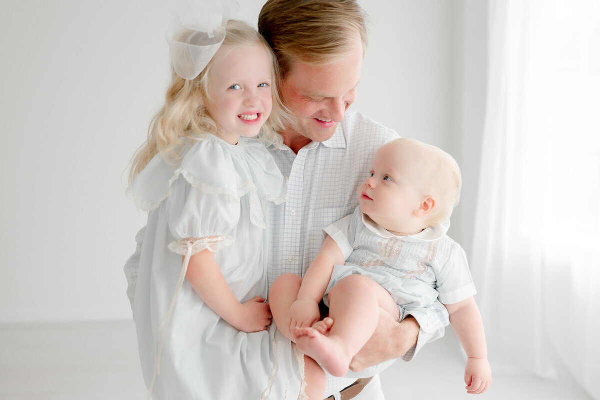 Father smiles at his baby son in Kristie Lloyd's studio