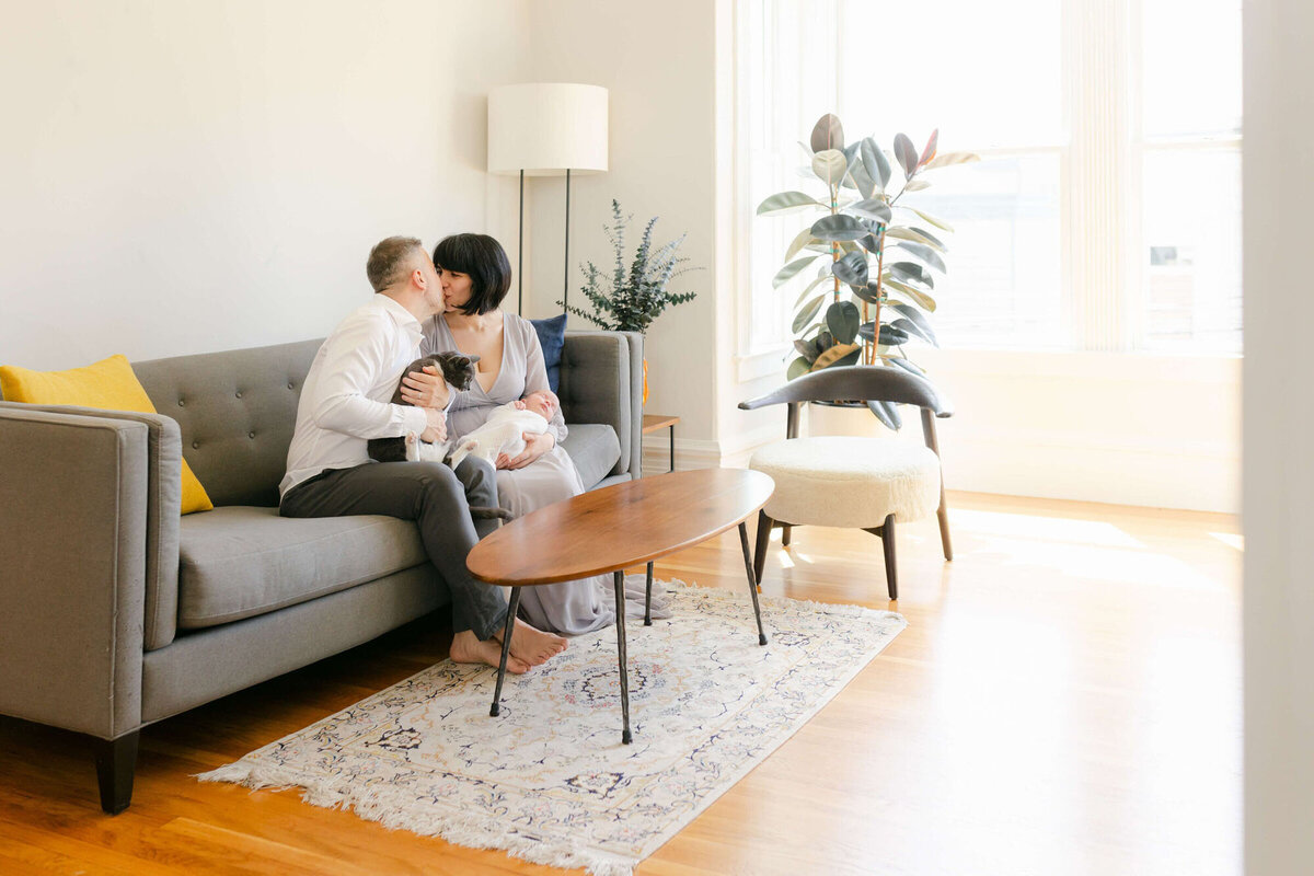 Cozy living room Bay Area newborn photography session with baby wrapped in a blanket.