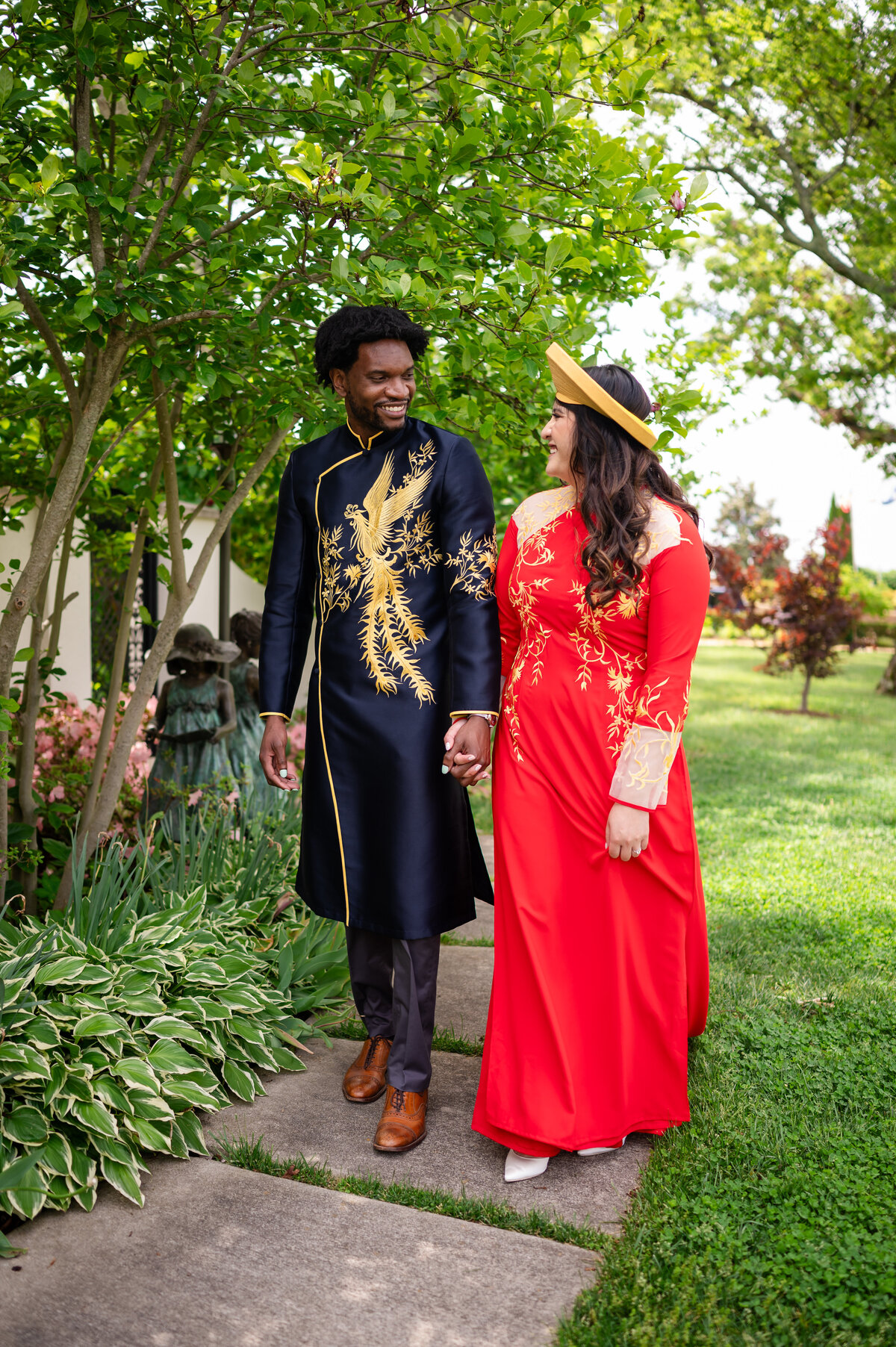 Engaged couple walks in garden