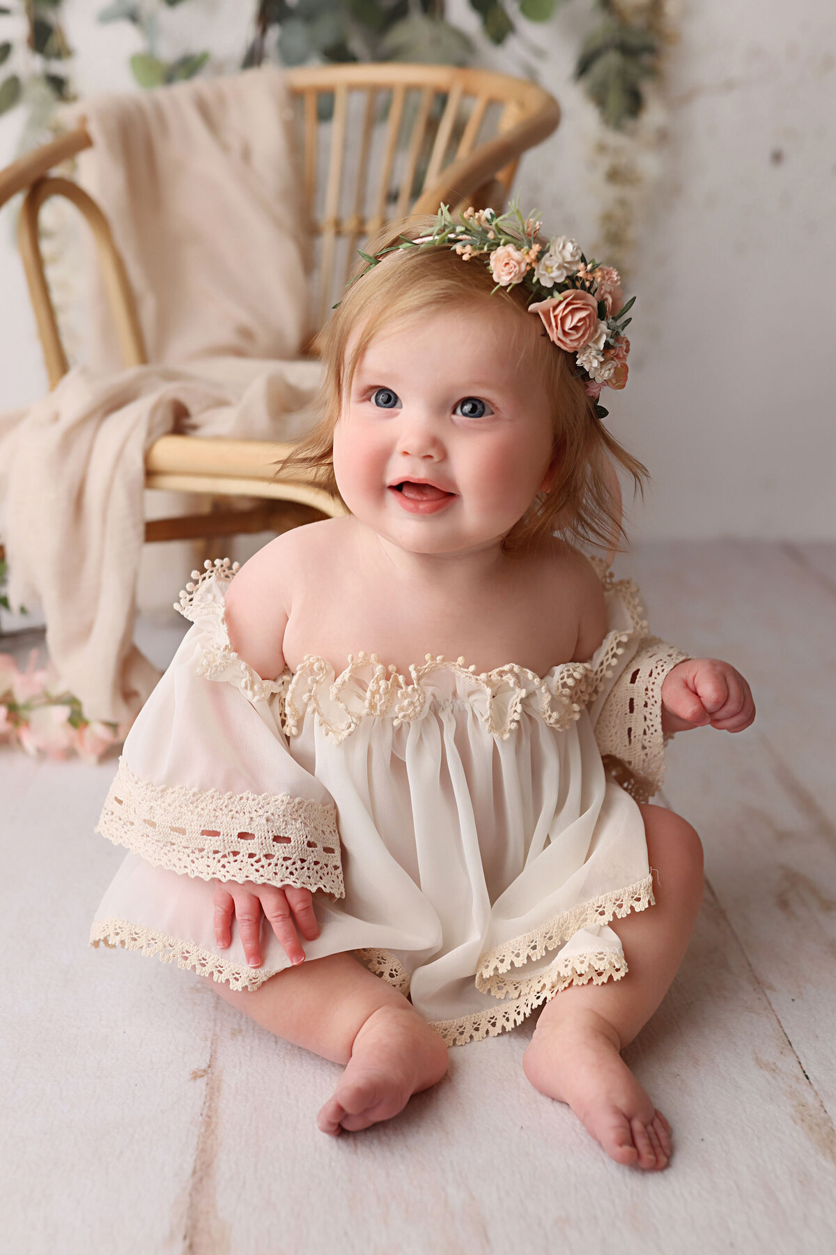 sweet baby during her NJ birthday photo session wearing a cream dress