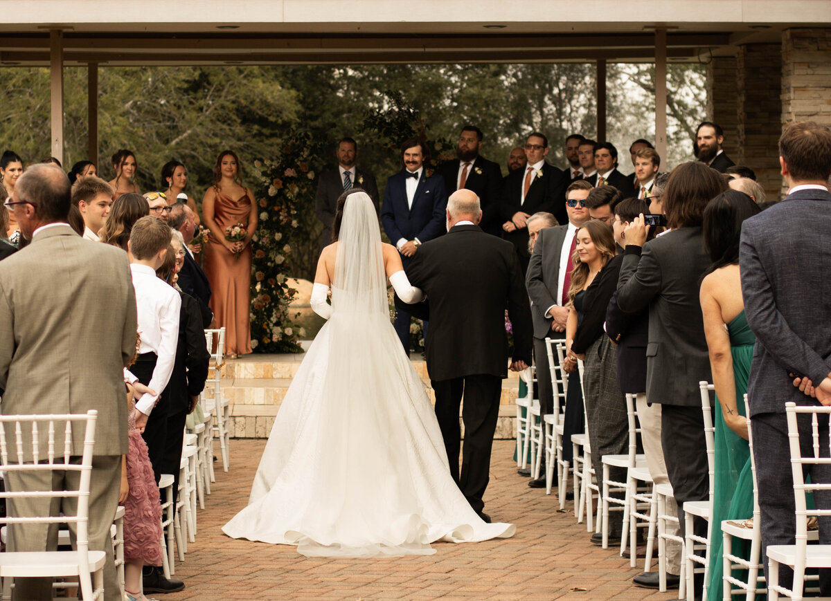 father of the bride walks bride down the isle