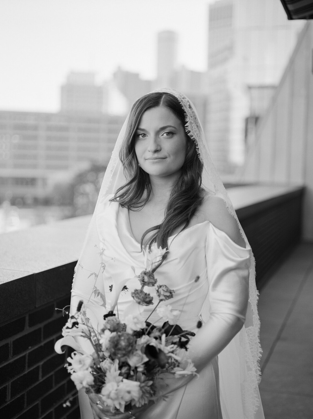 bride with lace mantilla veil and soft gaze at Shinola Hotel wedding in Detroit