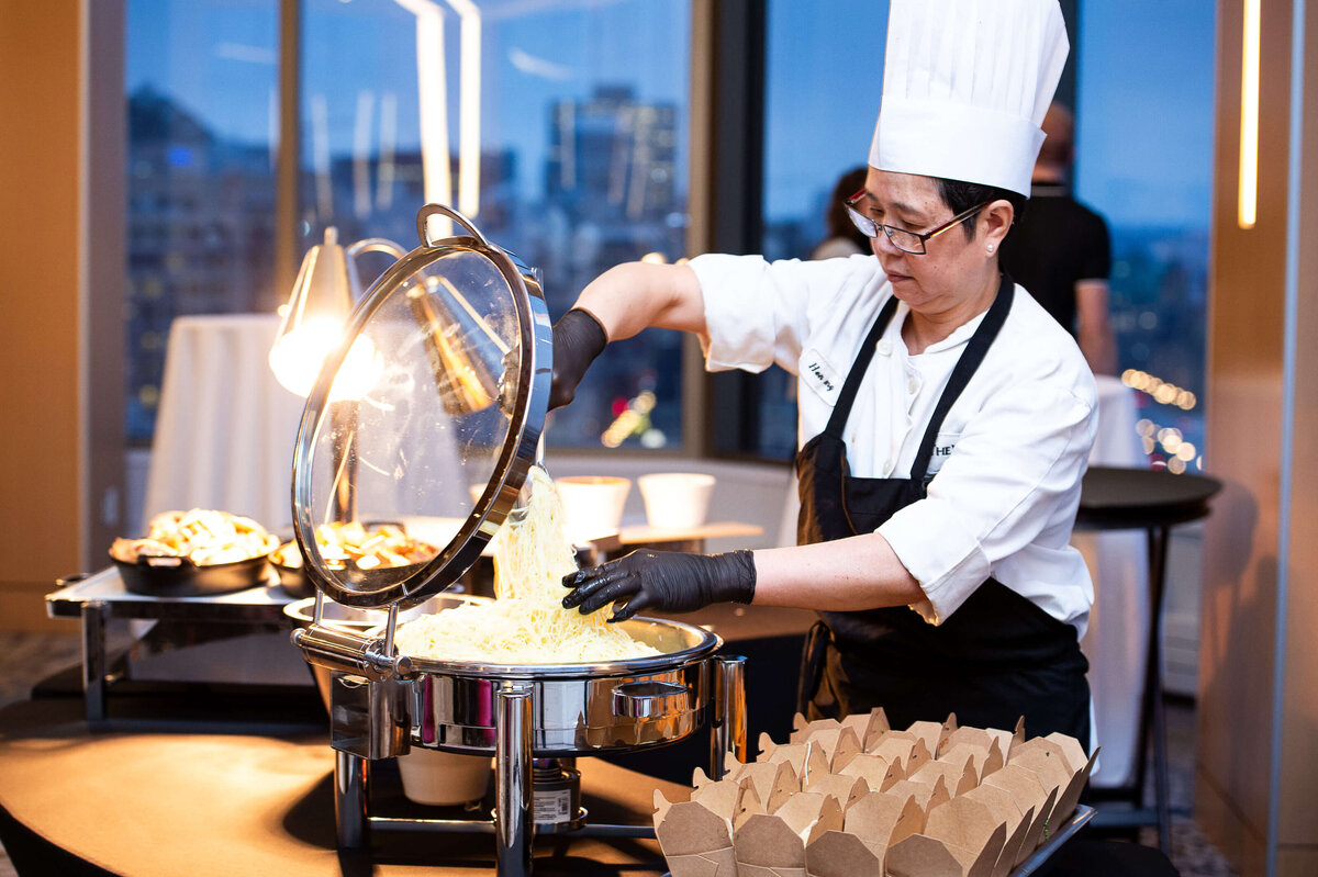 Ottawa event photography showing a caterer preparing and serving food during a multi-day corporate conference. Captured by JEMMAN Photography COMMERCIAL