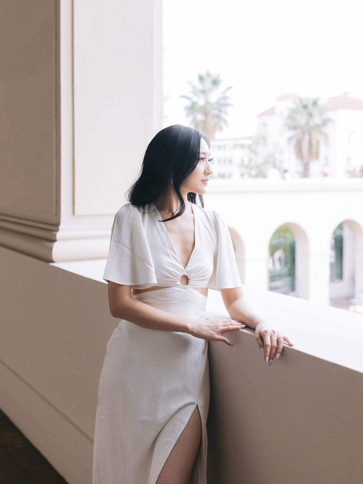 engagement photography of bride to be looking out the window of pasadena city hall