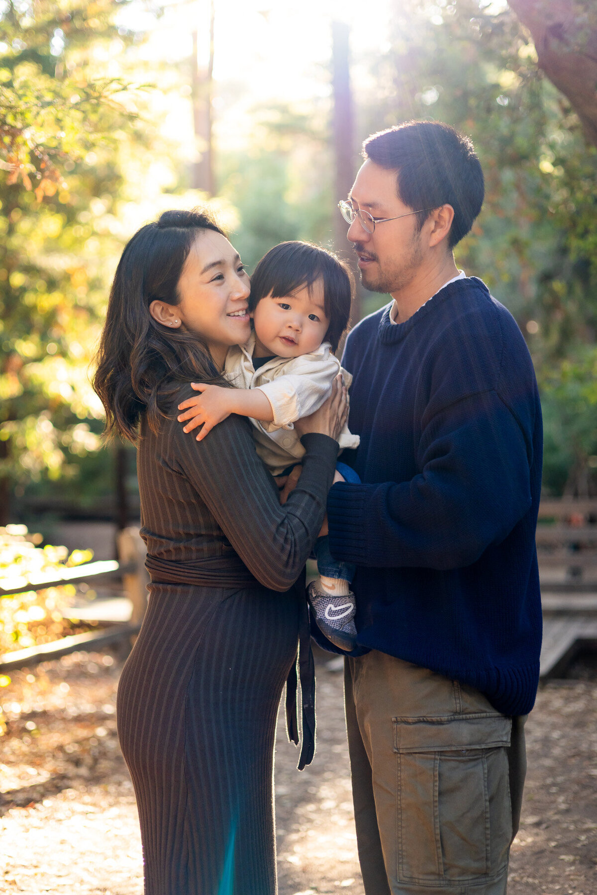 Loving family moment with parents holding toddler in the forest – Bay Area Family Portfolio | Ellobelle Photography