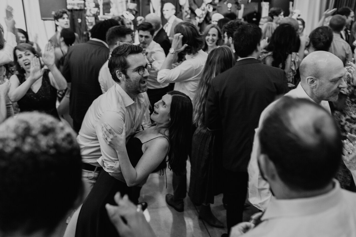 Black and white image of couple dancing at reception