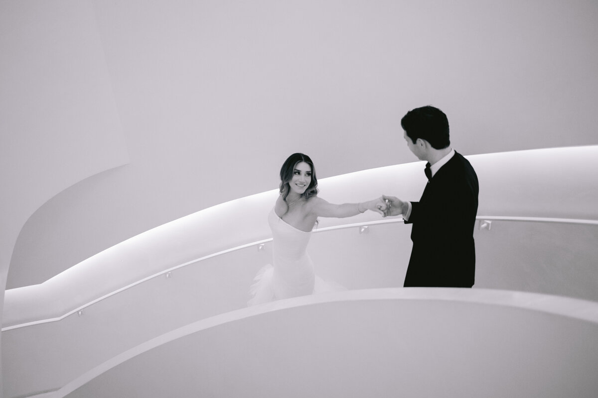 Modern Miami wedding portrait of bride and groom on a curved staircase.