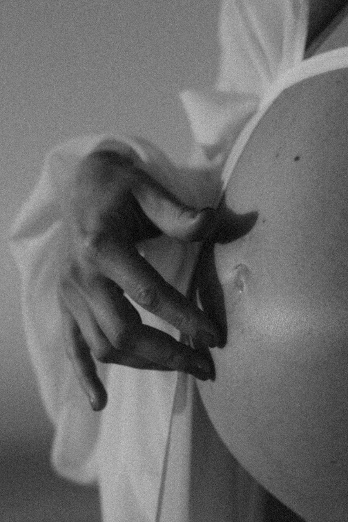 hand softly touching her pregnant belly
