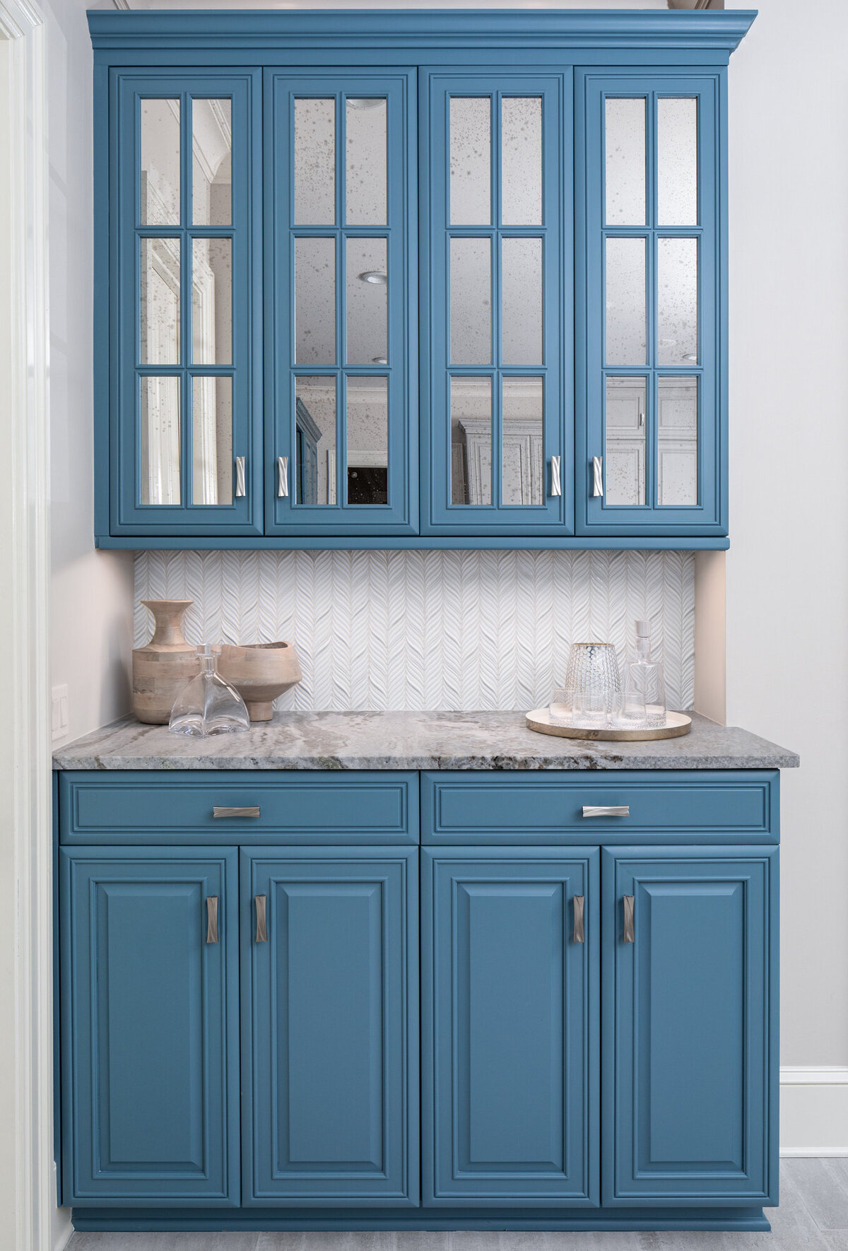 bar in kitchen with blue cabinetry