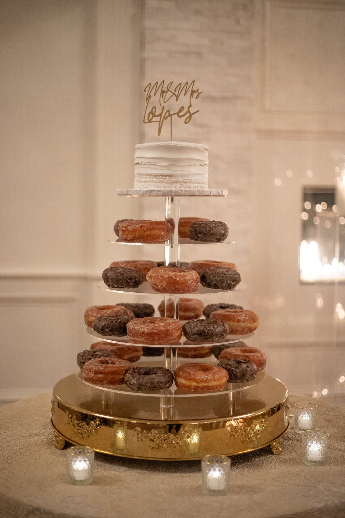 Dessert tray with donuts and wedding cake on top