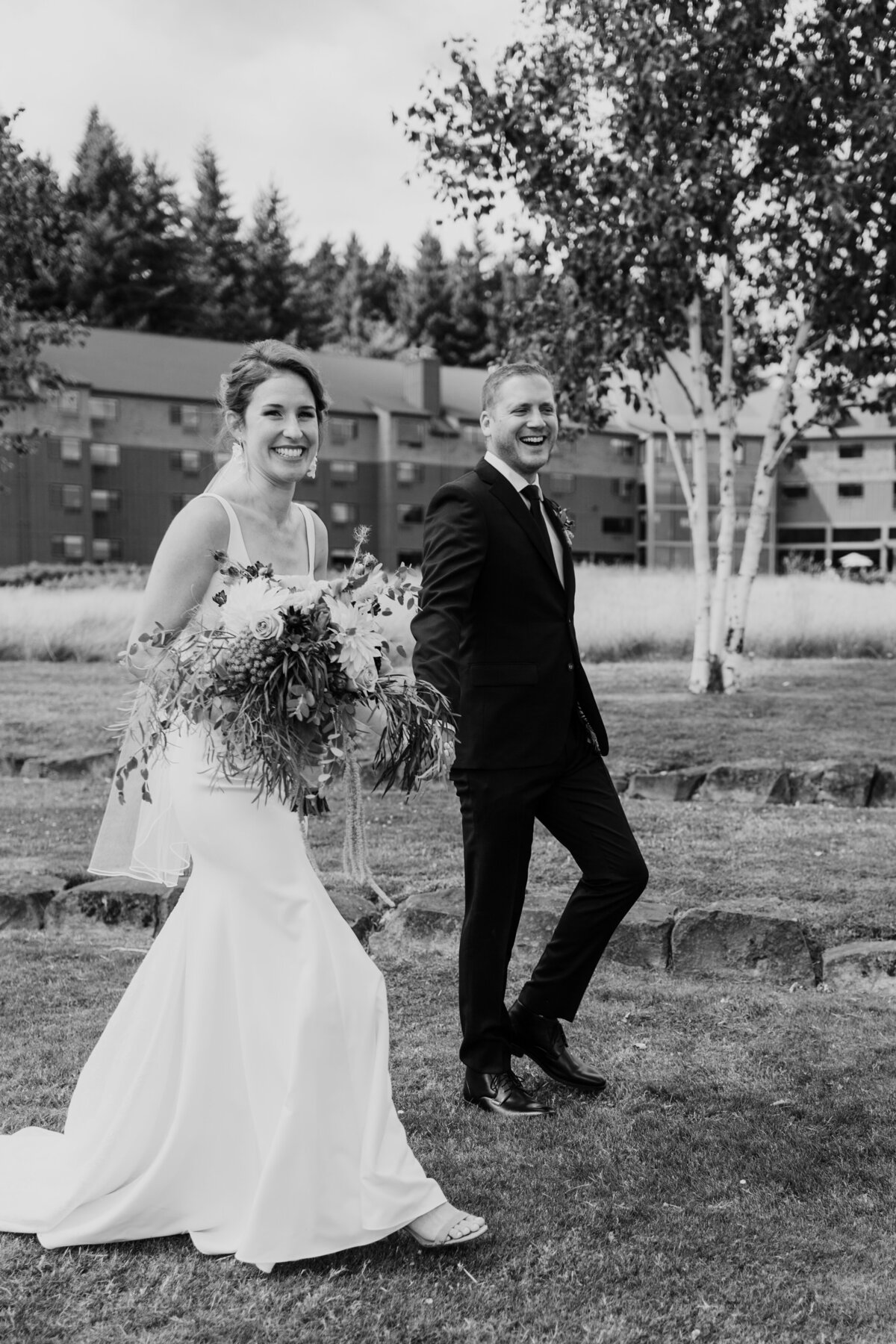 A happy candid of a couple walking at Skamania Lodge captured by Fort Worth wedding photographer, Megan Christine Studi
