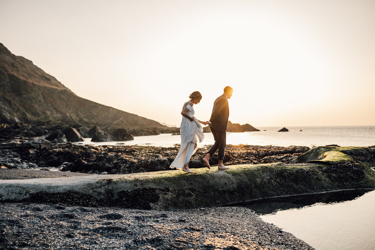 Bride and Groom sunset walk along the UK coast