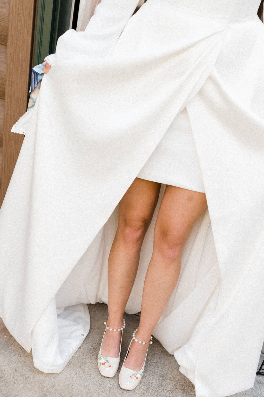 wedding dress falling around a brides shoes