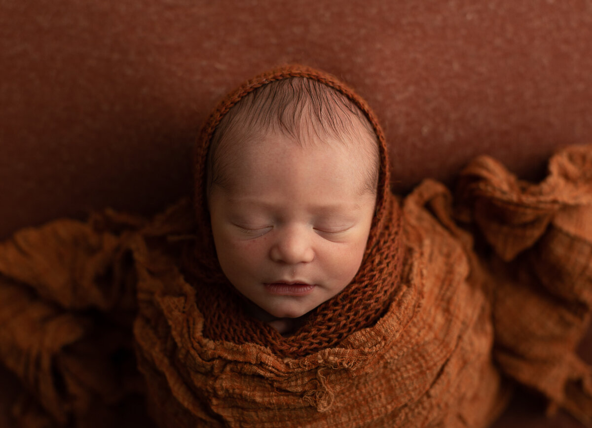 rust newborn set up with 8 day old baby boy for his newborn photos