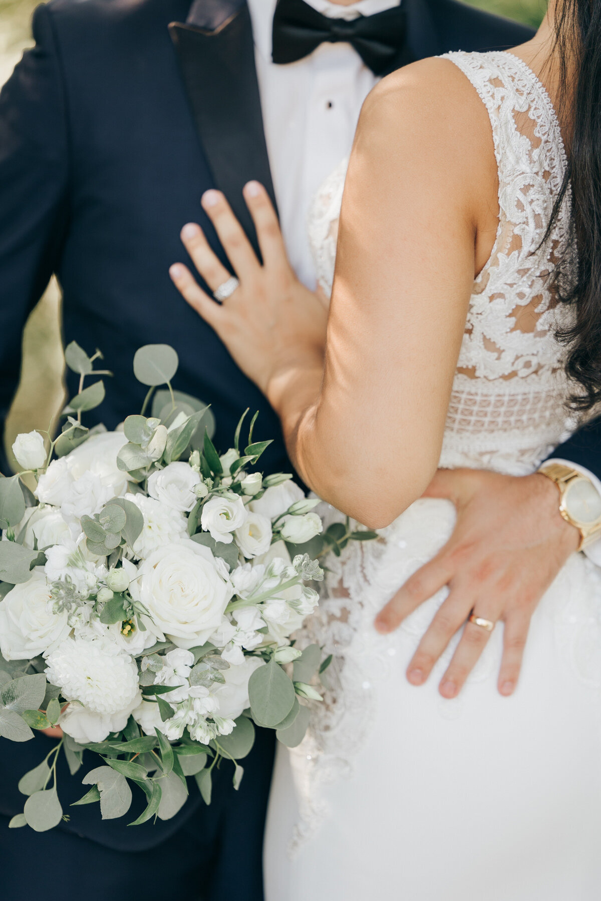 Elegant photo of a bride and groom that showcases both of their wedding rings