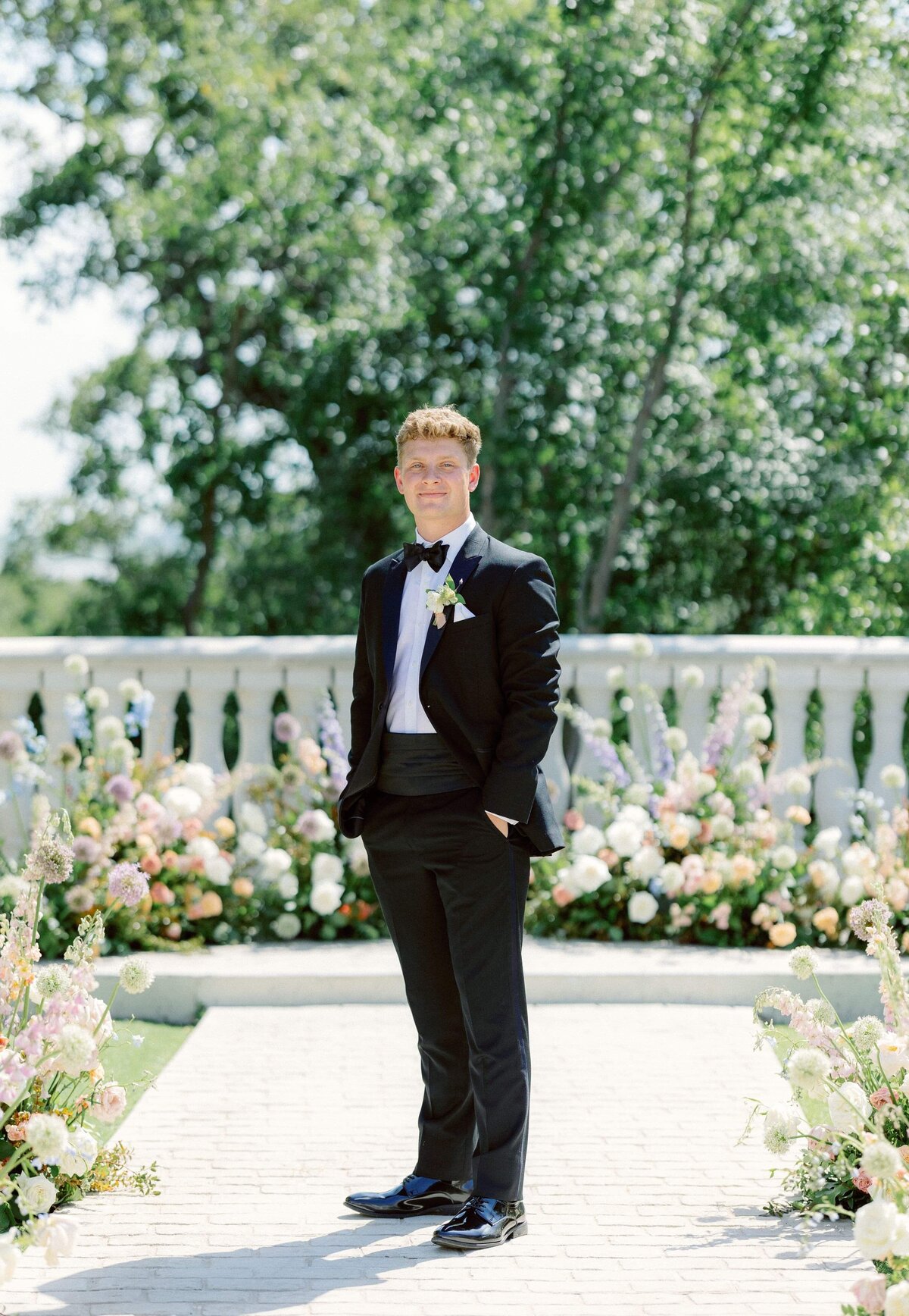 groom standing on path